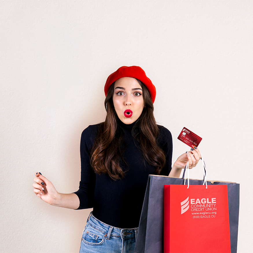 Girl holding credit card and bags